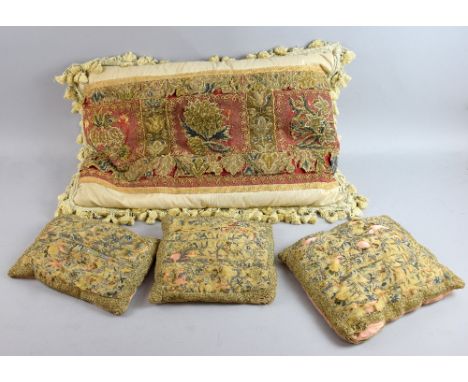 Three cushions with applied finely stitched silk embroidered fragments, depicting flowers in double chain stitch with raised 