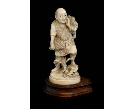 Early 20th century Japanese carved ivory okimono of a man calling out and holding a basket, signed to base, 13cm high, on non