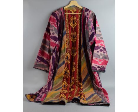 Three chapan robes in ikat silk lined with printed cotton fabric. Silk woven in traditional geometric patterns in pinks, purp