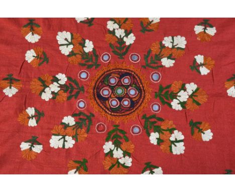 An Indian embroidered head shawl, Sind Rajasthan, first half 20th C, red cotton, three circles set with mirrors,  floral spri