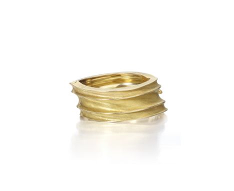 An 18k gold bangle,  Buccellati, Italythe hinged bangle of twisted sculptural design, with grooves featuring fine rigato gold