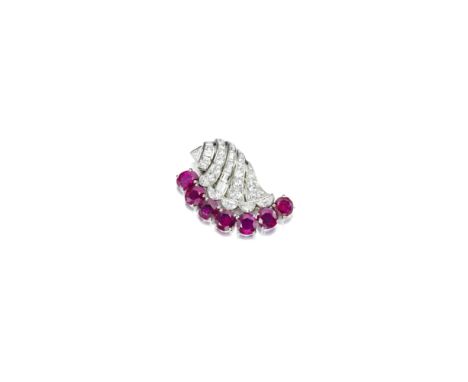 A ruby and diamond broochdesigned as a stylized shell, set with old mine and baguette-cut diamonds, to the half-moon and tria