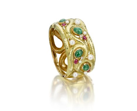 An 18k gold, diamond and gem-set bangle, Italythe scrolling openwork hinged bangle created in hammered gold with emerald and 