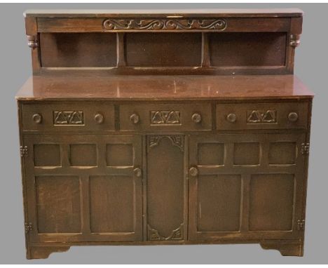PRIORY OAK STYLE BUFFET SIDEBOARD having three frieze drawers and twin lower cupboard doors, all with turned wooden knobs, 11