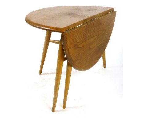 An Ercol elm circular drop-leaf coffee table on beech legs, max. w. 60 cm CONDITION REPORT: Some wear, structurally sound