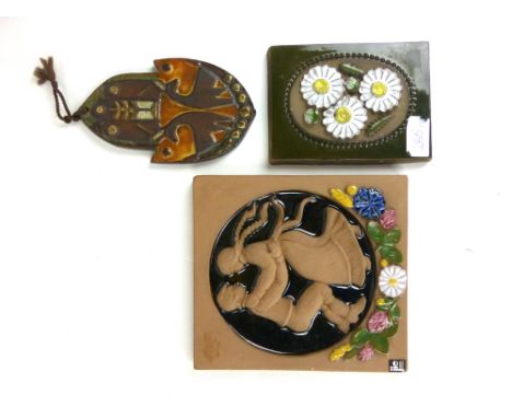 Aimo for Jie of Sweden, a ceramic wall tile decorated with raised flowers on a green ground, l. 16 cm, together with two othe