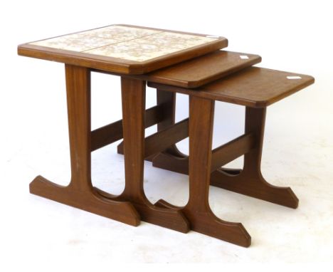 A nest of three G-Plan tile topped and teak coffee tables, max. w. 49.5 cm CONDITION REPORT: Structurally sound, wear commens