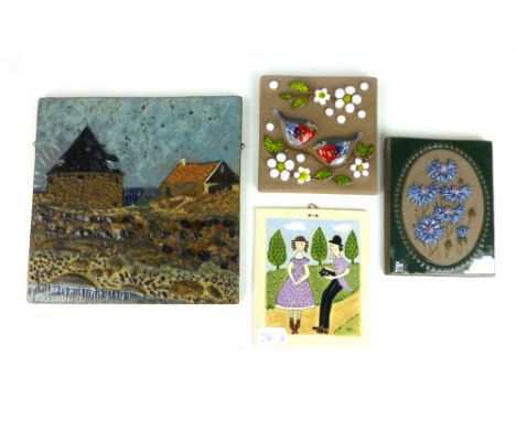 A large Swedish wall tile depicting stylised cottages, l. 26 cm, together with an unmarked tile and two others by Jie and Dec