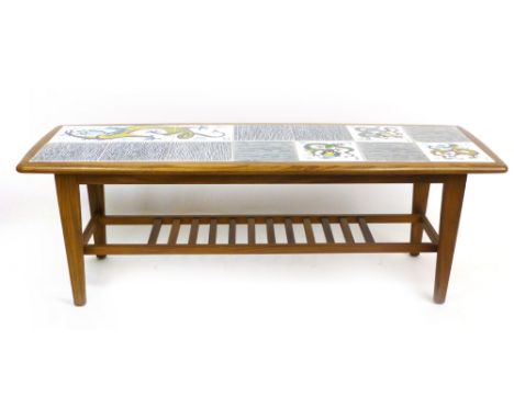 A 1970's tile topped and teak coffee table of rectangular cushioned form with a second tier, l. 105 cm CONDITION REPORT: Wear