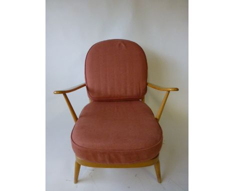 An Ercol beech lounge chair with loose cushions 