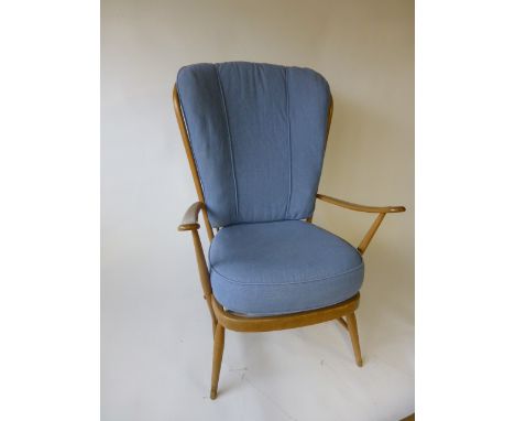 An Ercol beech high back armchair with loose cushions 