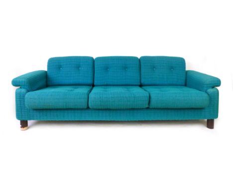 A 1970's low three-seater sofa with blue and turquoise upholstery on mahogany circular legs, l. 207 cm CONDITION REPORT: Stru