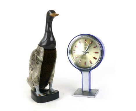 A Fortnum and Mason bakelite clothes brush in the form of a duck, together with a blue cased mantle clock Coral  CONDITION RE