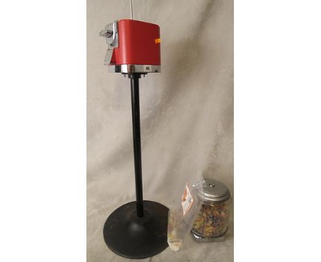 A vintage, early 1980s retro bubble gum vending machine on stand, with sweets