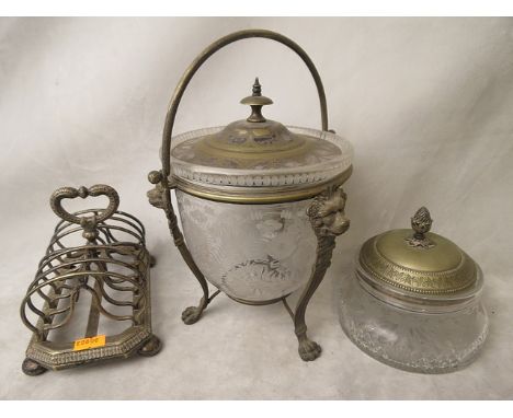 A Victorian glass and silver plated pot cover, the glass bowl with fern and leaf swaged decoration, sitting in a lion head si