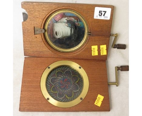 Two Victorian mechanical lantern slides, Man Eating Rats and Chromatrope, both with brass and turned wooden handles
