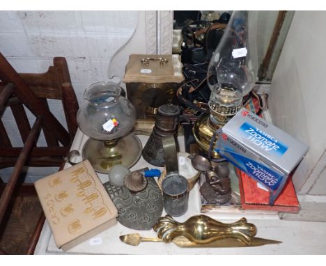 A BRASS OIL LAMP a mantel clock, playing cards, metalware and sundries