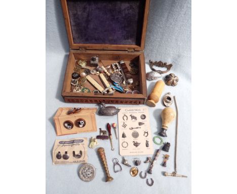 A 19TH CENTURY HARDSTONE SEAL with ivory handle, a card of vintage pudding charms, and other small collectibles, in a carved 
