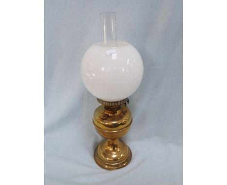 A BRASS OIL LAMP with white opaque shade