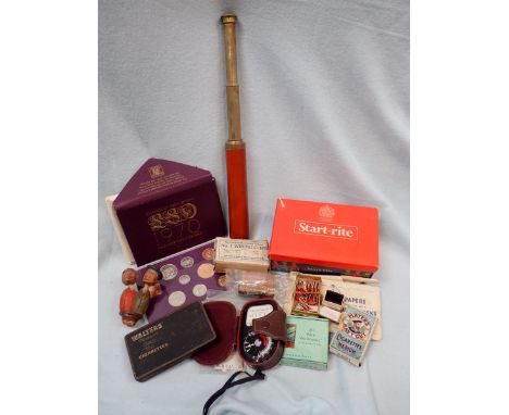 A BRASS TELESCOPE WITH LEATHER COVER a light meter, a set of 1970 coins, cigarette packets and sundries