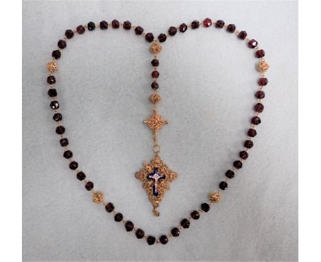 A 19TH CENTURY STAMPED FILIGREE GILT METAL ROSARY with double-sided enamel crucifix (one side damaged) and ruby glass decade 