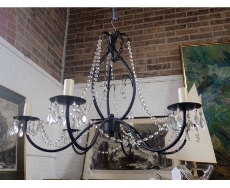 A CONTEMPORARY BLACK METAL CHANDELIER with glass droplets