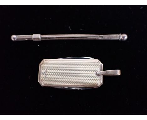 A SILVER CHAMPAGNE SWIZZLE STICK with engine turned decoration and stamped 'sterling' and a silver pen knife