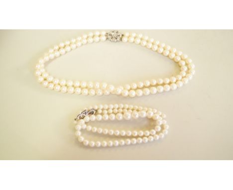 A cultured pearl two strand necklace, with 9ct white gold clasp set diamonds, 37cm; together with another single strand cultu