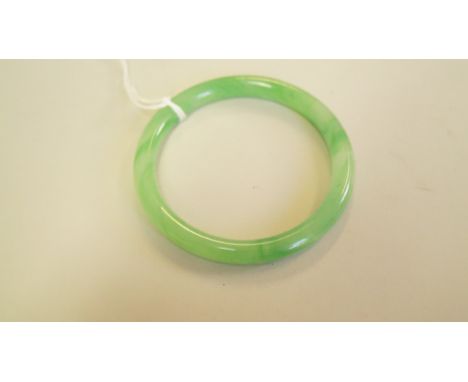 A Chinese jade bangle, 8.3cm outer diameter.