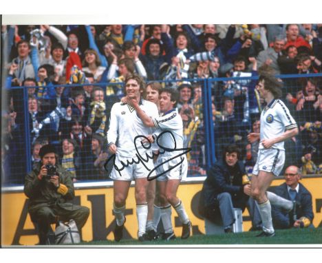 Autographed 12 x 8 photo, TONY CURRIE, a superb image depicting the Leeds United midfielder celebrating with team mates Graha