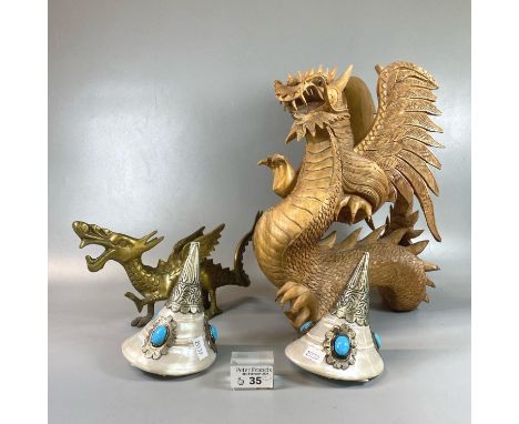 Carved wooden sculpture of a dragon, together with a brass dragon and a pair of Tibetan conch shells with white metal mounts 