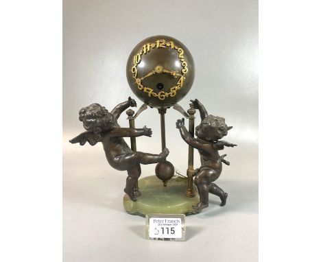 Early 20th century bronzed metal globe clock, having single train movement with gilt Arabic numerals, exposed pendulum and tw