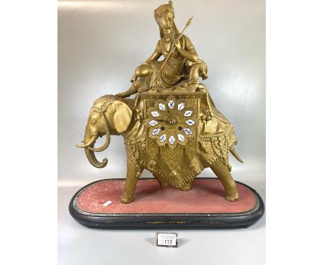19th century gilded metal two train mantle clock in the form of a Carpisoned Indian Elephant with Mahout, having ceramic Roma