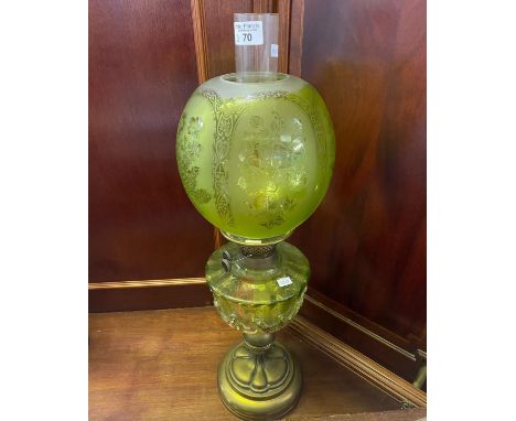 Early 20th Century double oil burner lamp having green frosted glass globular shade above a green reservoir on an Art Nouveau