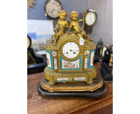 Large 19th century French ormolu figure mounted two train mantle clock, the arched top surmounted by two cherubs, ceramic Rom