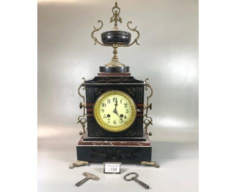 Late 19th century black slate two train mantle clock with gilt metal mounts, urn shaped finial and Arab ceramic face.  Overal