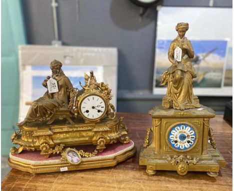 Two 19th century gilt spelter figural mantle clocks, both with ceramic Roman faces, one on additional base.  (2)  (B.P. 21% +