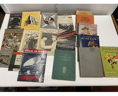 A job lot of vintage annuals and military related books including 1955 Guinness Book of Records.