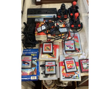 A vintage Atari Console games console with various controllers, game cartridges etc including Space Invaders (untested)