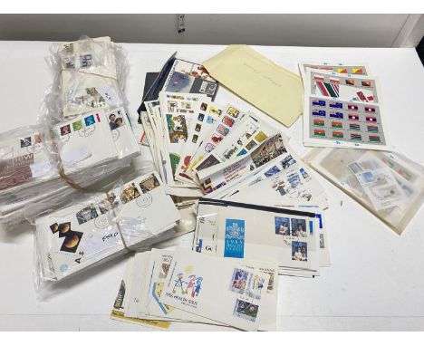 A box full of first day covers and selection on mint stamps