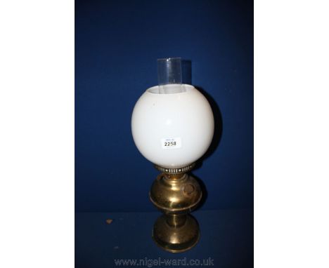 A Brass Oil Lamp with clear chimney and white glass globe, 19" tall.