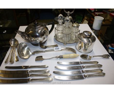 A quantity of silver plated items including assorted cutlery, four piece cruet on stand, teapot and caddy