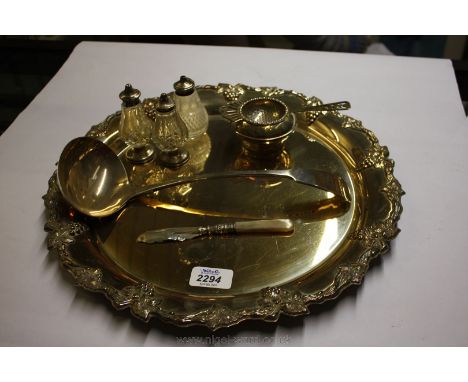 A silver plated circular Tray, ladle, tea strainer and three piece silver topped Cruet