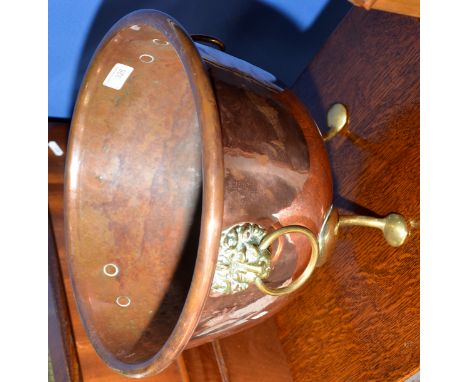 Large copper planter on three raised supports and lion mask handles 