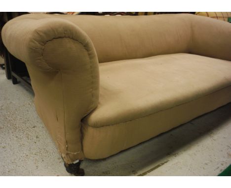 A Victorian scroll arm Chesterfield sofa in beige upholstery, raised on mahogany turned legs to brass castors