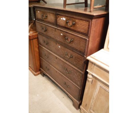 An oak and cross banded chest of two short over four long drawers to bracket feet