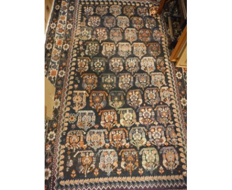 A Caucasian carpet, the central panel set with a repeating stylised motif decoration on a dark black ground within a stepped 
