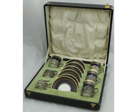 A cased part set of Copeland Spode coffee cans and saucers, the cups with silver mounts (Sheffield 1910 by Walker & Hall), we