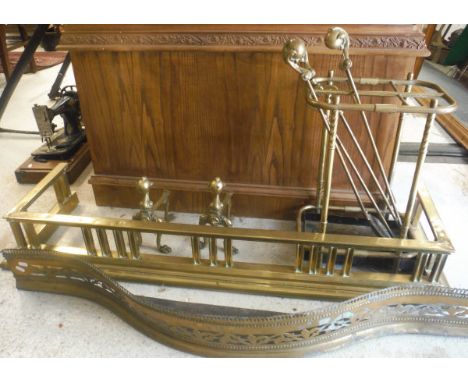 Two brass fire kerbs, a pair of brass fire dogs, brass fireside companion tools and a brass six section umbrella stand