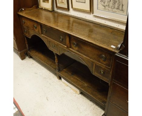 An early 19th Century oak dresser, the plain top above three long drawers above two short drawers to pot shelf beneath